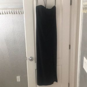 Long black formal sleeveless dress.